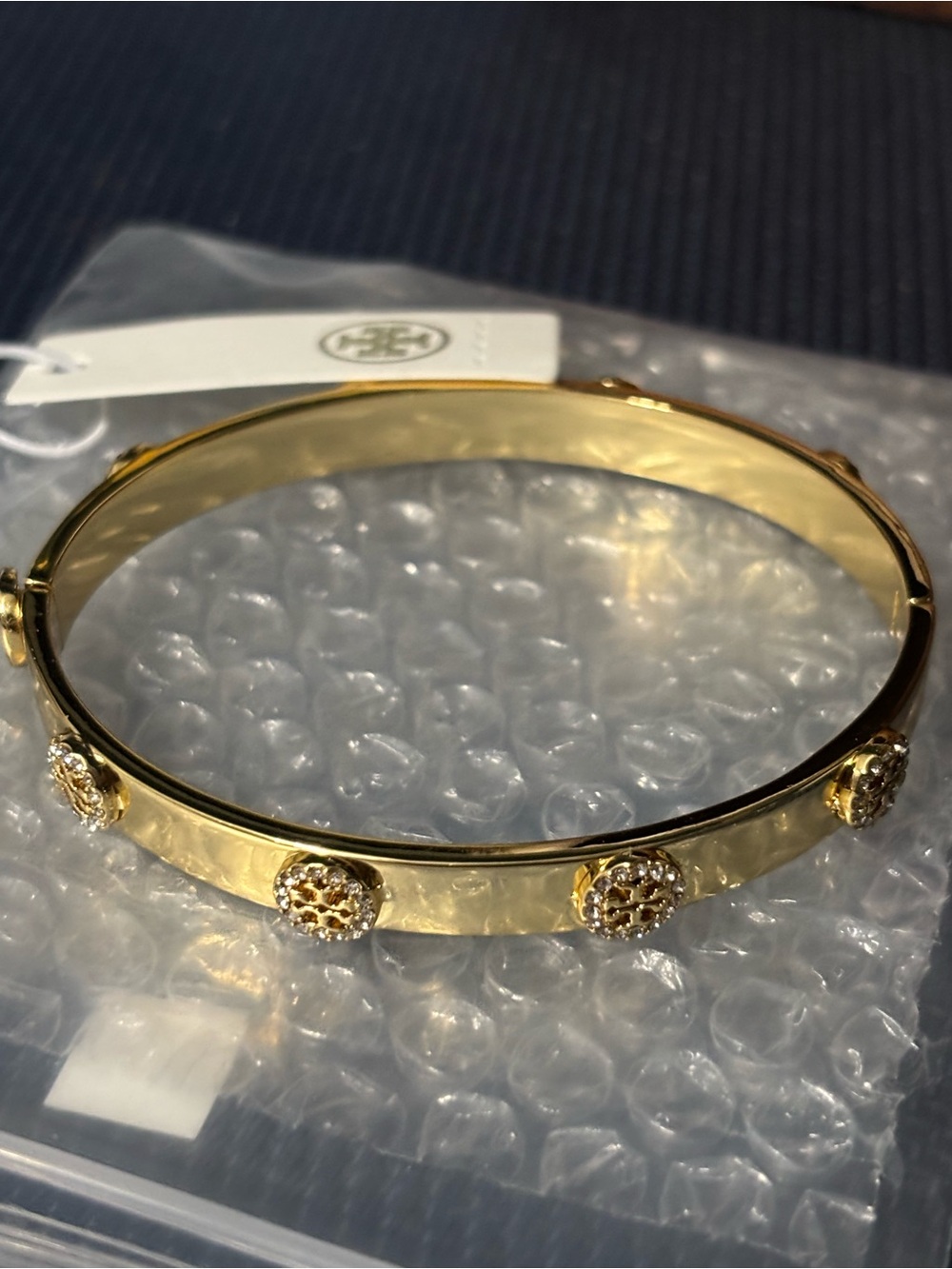 Brand new Tory Burch Gold Logo Accent Hinged Bangle Bracelet